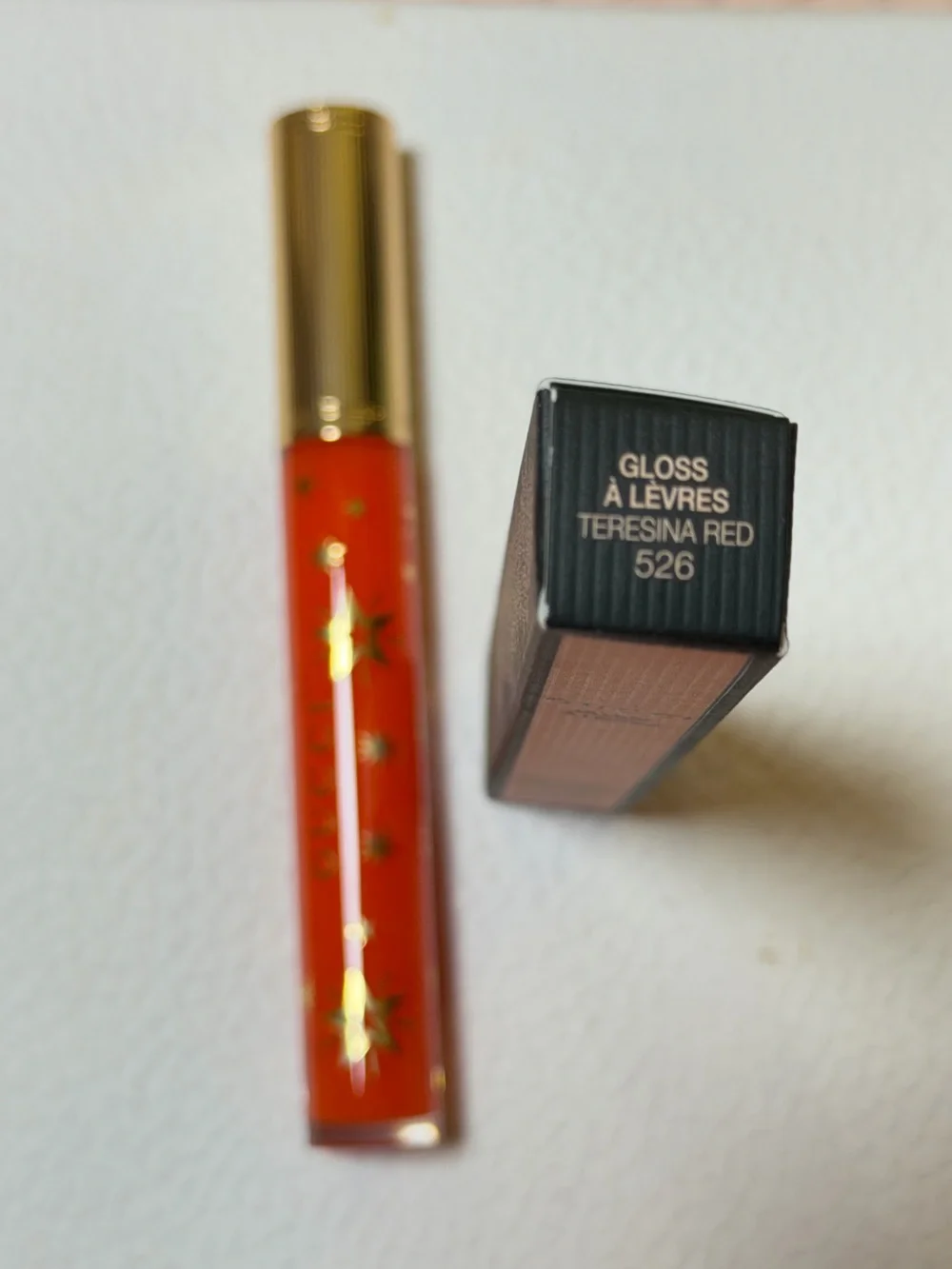 Gucci Orange-Red Lip Gloss with Gold Star Accents